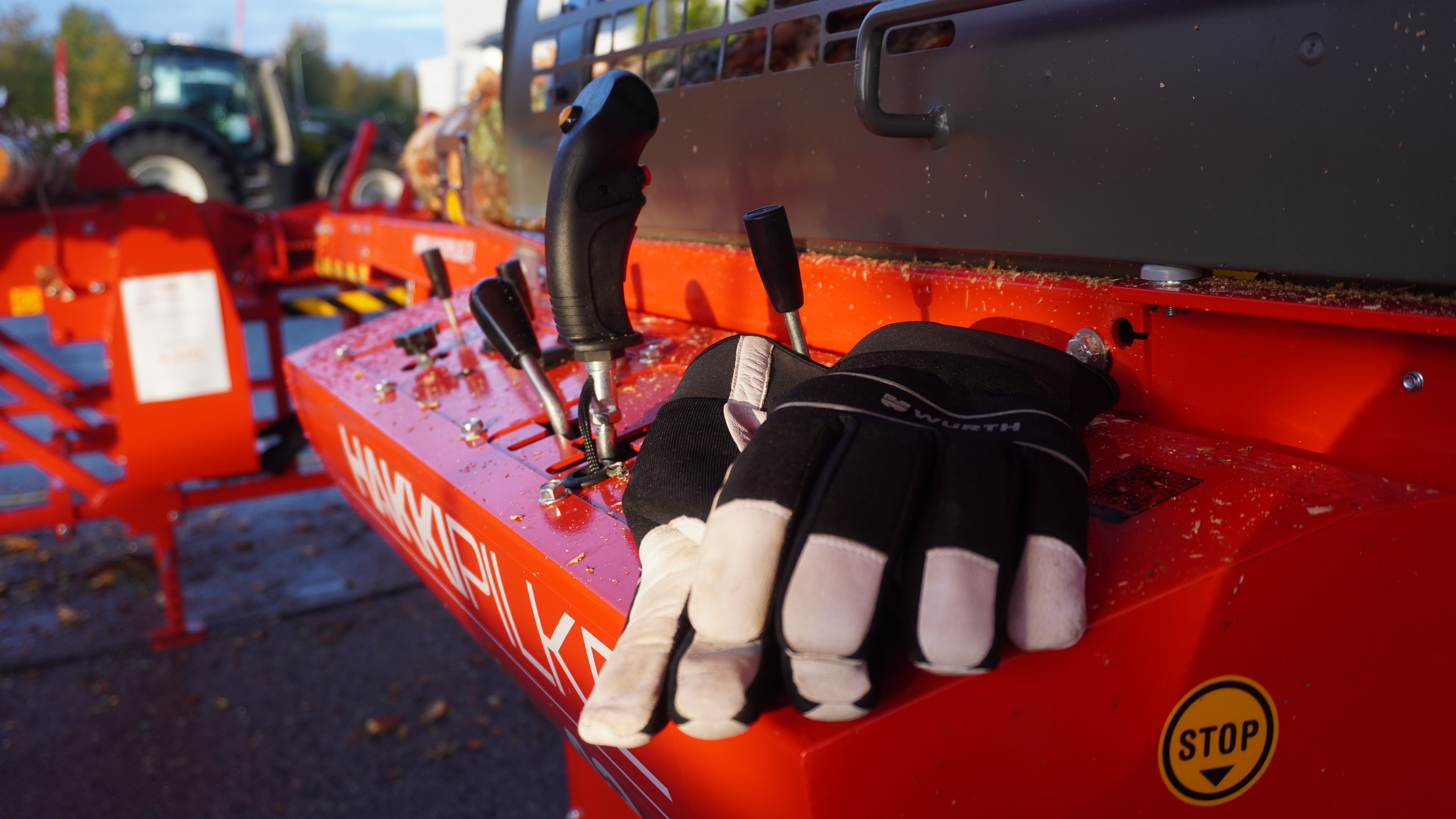 Proper work gloves set on the control panel of a firewood processor