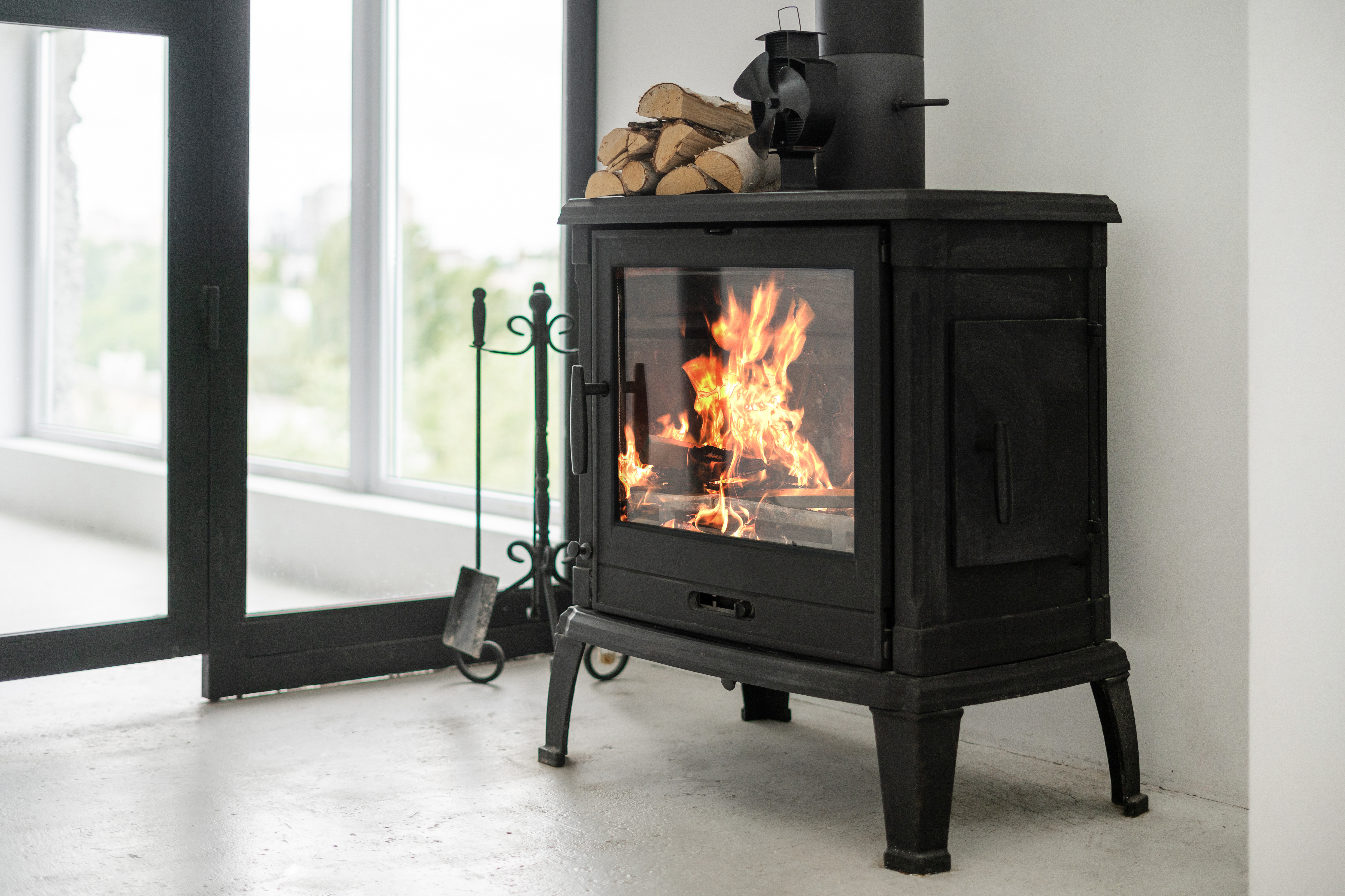 Modern black fireplace with fire inside. 